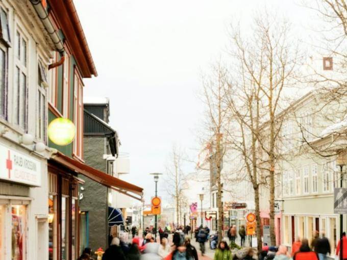 People walking along a shopping street in downtown Reykjavík